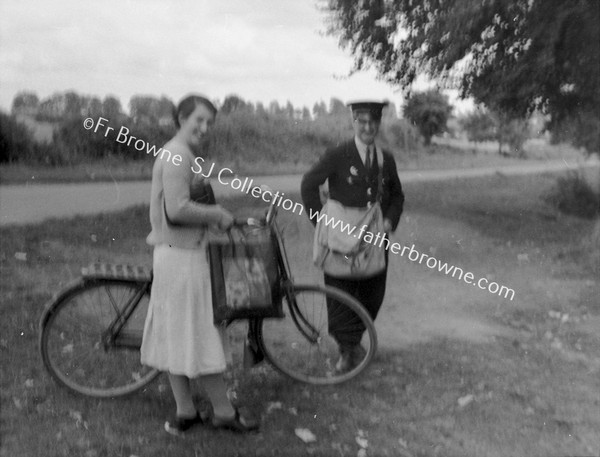 LADY CYCLIST MEETS POSTMAN